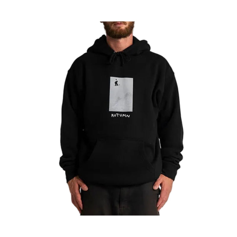 A man wearing a black pullover hoodie with a square gray graphic print on the chest and the brand name Autumn printed below it, set against a plain light gray background.