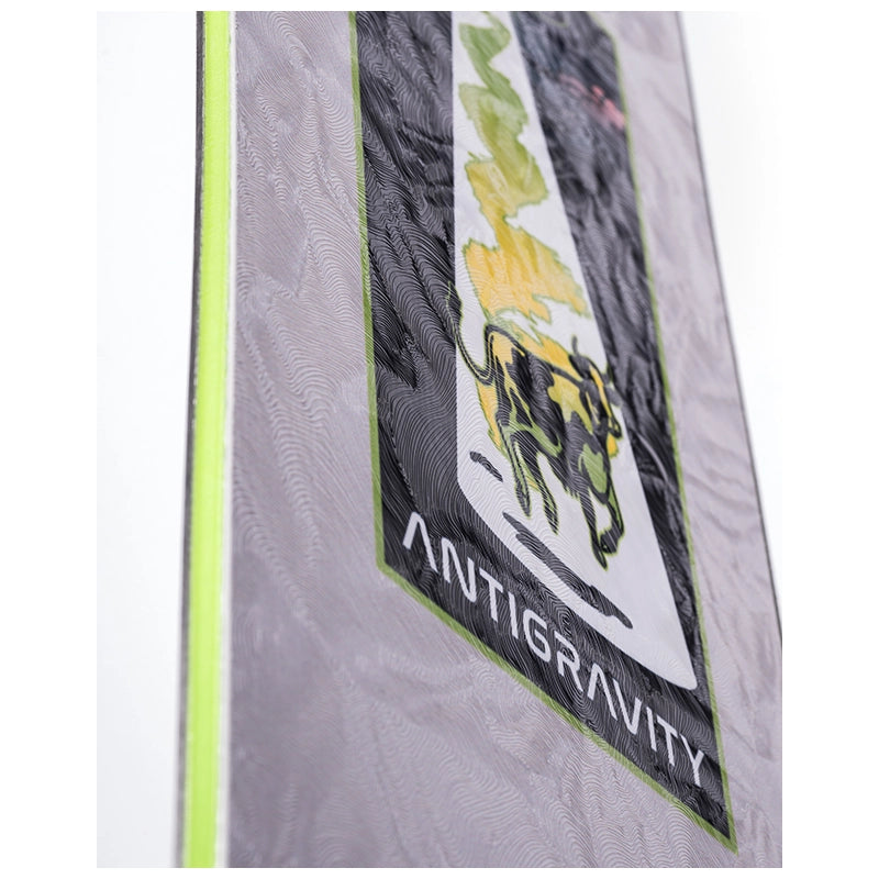 Close-up of a gray Antigravity ski or snowboard with a black, white, and lime green graphic design and the brand name 'ANTIGRAVITY' printed on it.