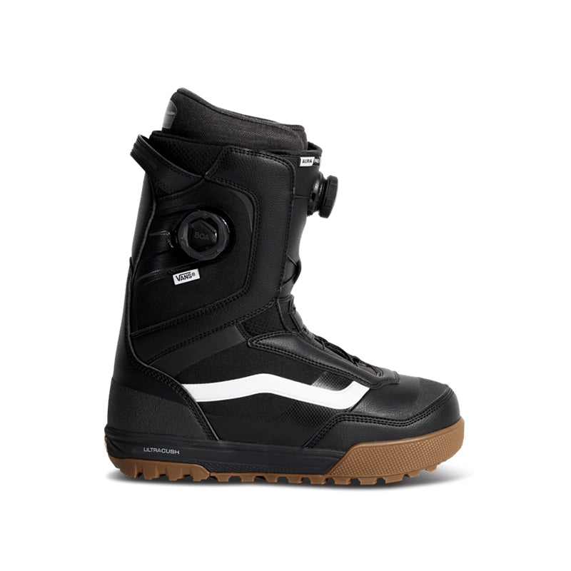 A single black Vans snowboard boot with a white side stripe, a dial closure system, and a brown gum sole, shown against a plain white background.