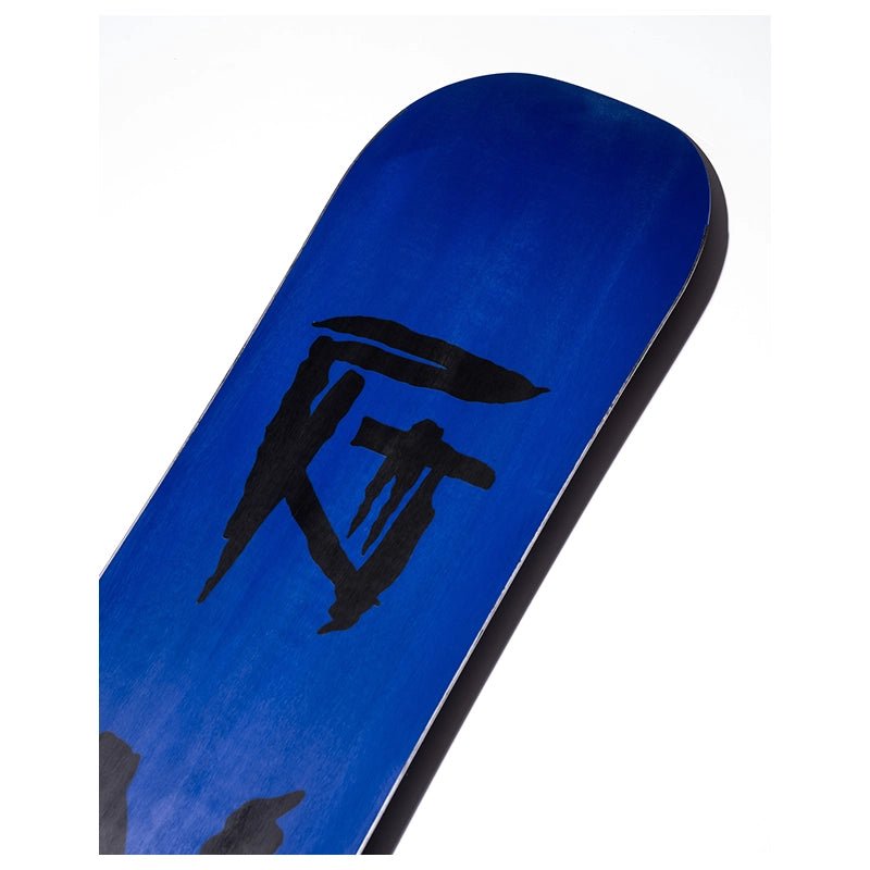 A close-up of a blue snowboard base featuring a large black brushstroke graphic, photographed against a plain white background.