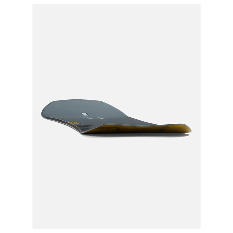 A single snowboard shown from a side profile view against a clean, light gray background. The snowboard features a dark gray top sheet and a translucent amber-brown base.