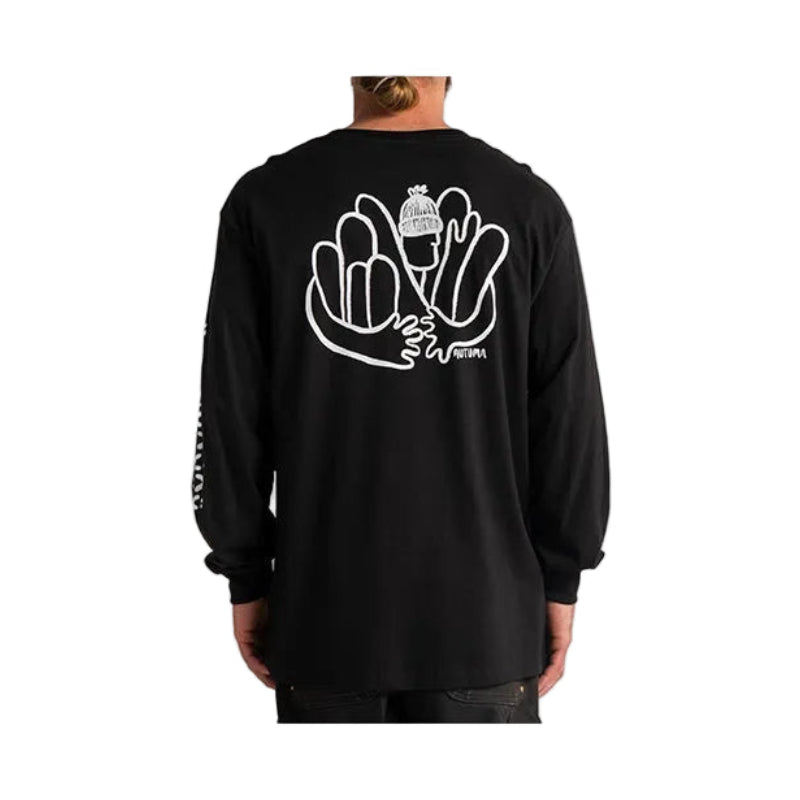 A person viewed from the back wearing a black long-sleeve shirt with a large white graphic print on the back and smaller white text down one sleeve, against a light gray studio background.