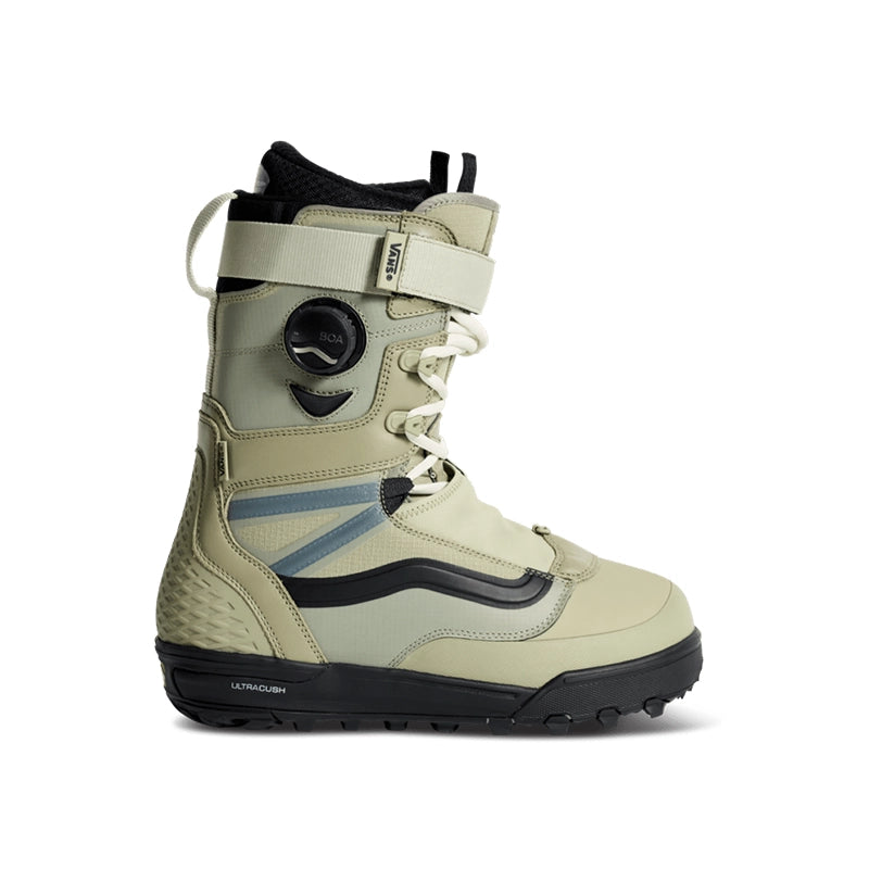 A single snowboard boot in a light beige/khaki colorway with black and dark gray accents, featuring a dial closure system and a textured knit footbed, shown against a plain white background.
