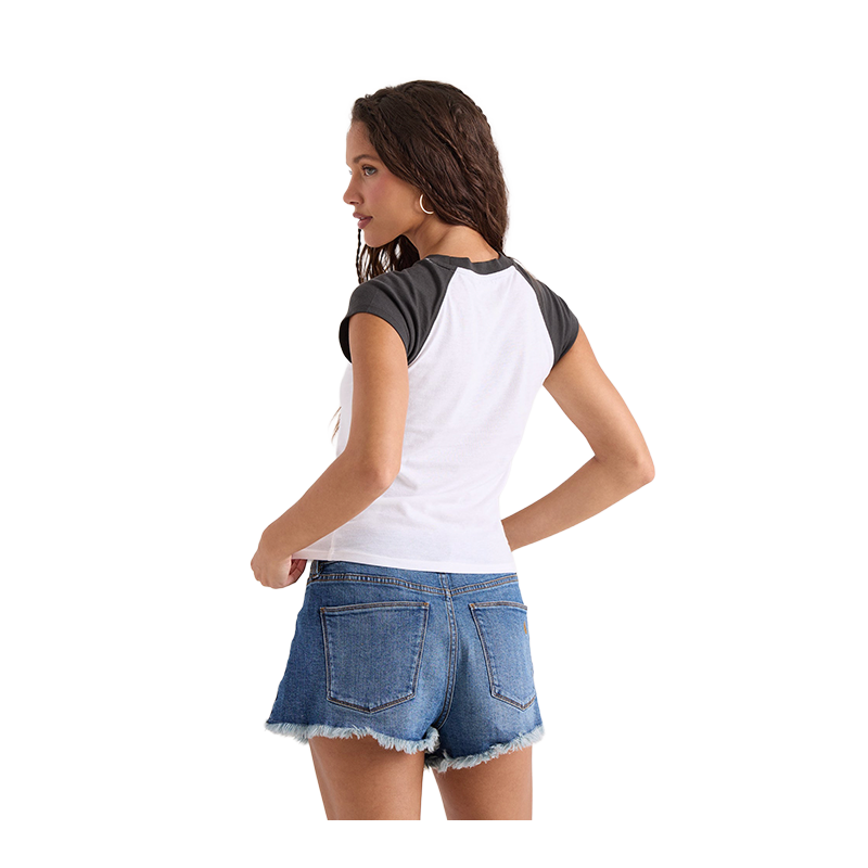 A woman shown from the back wearing a white and dark gray raglan baseball t-shirt and blue denim shorts with a frayed hem, set against a plain white background.