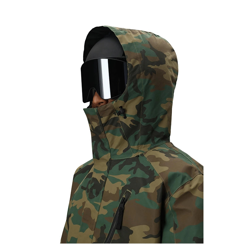 A person wearing a hooded camouflage jacket and black ski goggles, shown in profile against a plain white background.