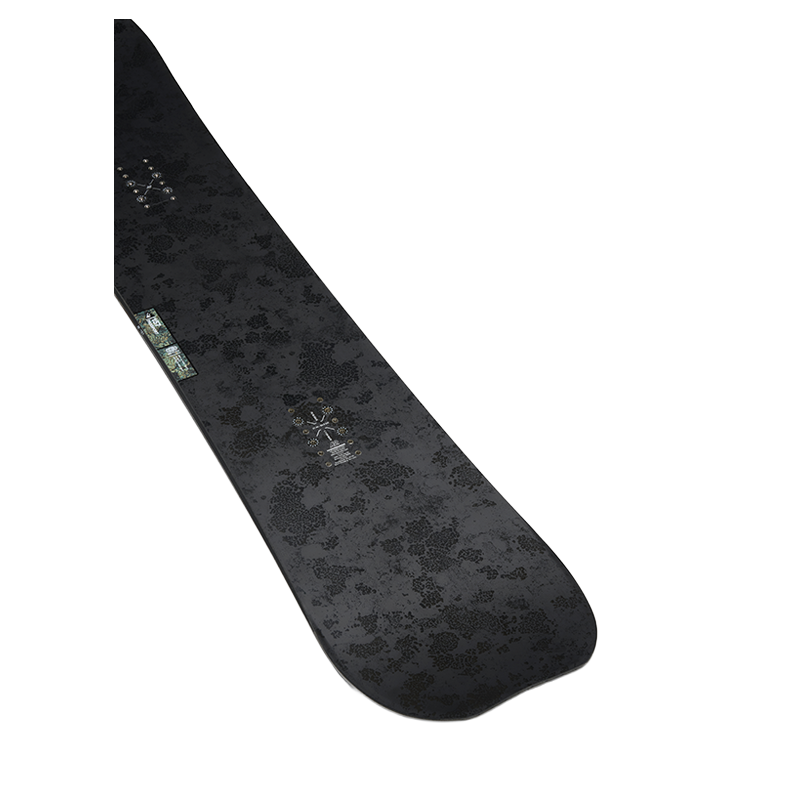 A black snowboard with a subtle dark gray floral pattern and a small green-and-white logo near the tail, shown on a plain white background.