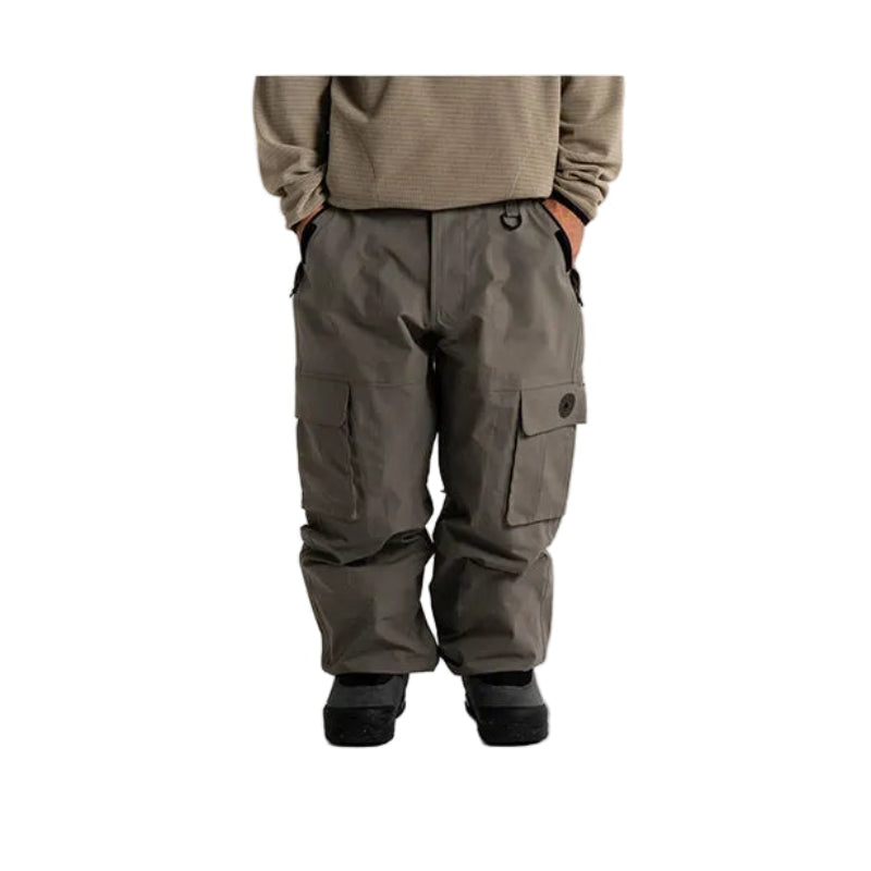 A person shown from the chest down wearing dark gray cargo pants, a ribbed olive-khaki long-sleeve top, and black boots against a plain white studio background.