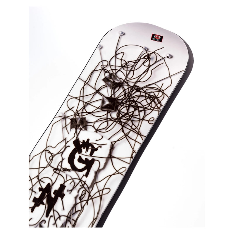 A rectangular wall art panel with rounded corners, featuring a white background covered in dense black abstract scribbled lines and a few black star-like shapes. A small red square logo is visible near the top right corner.