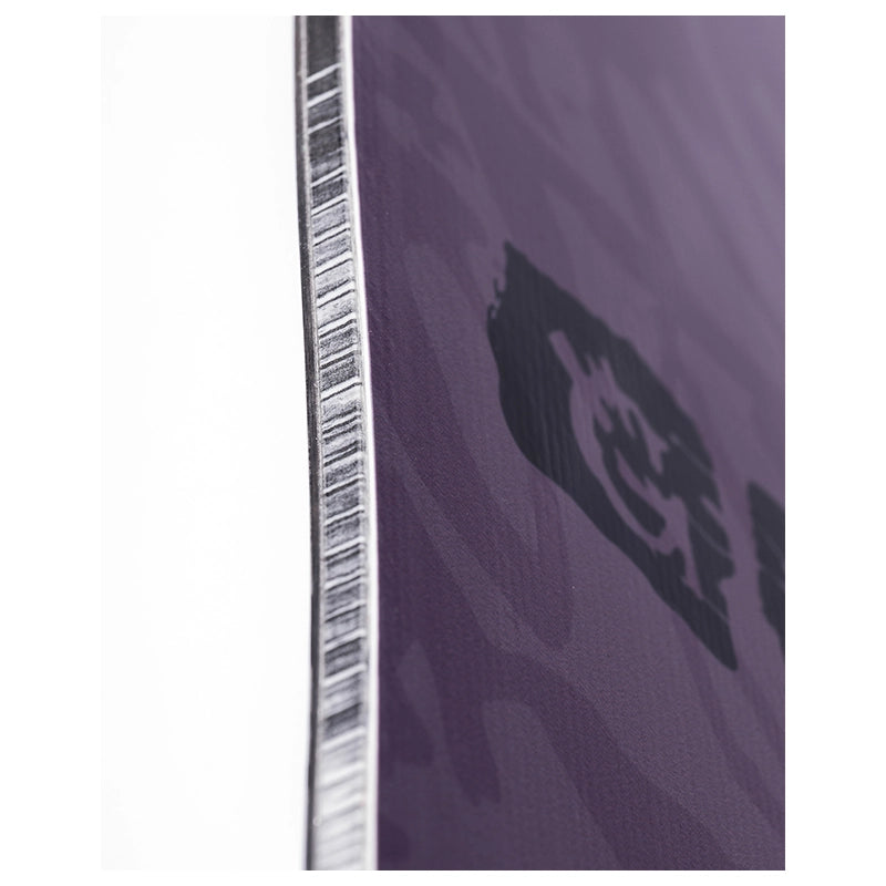 Close-up of a purple textured surface with a black abstract logo or emblem and a narrow white vertical strip along the left edge.