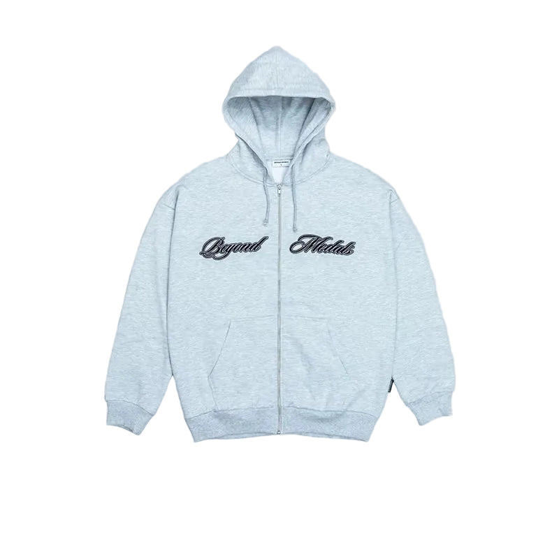 A light heather gray zip-up hoodie with 'Beyond Medals' printed in black script across the chest, displayed on a solid gray background.