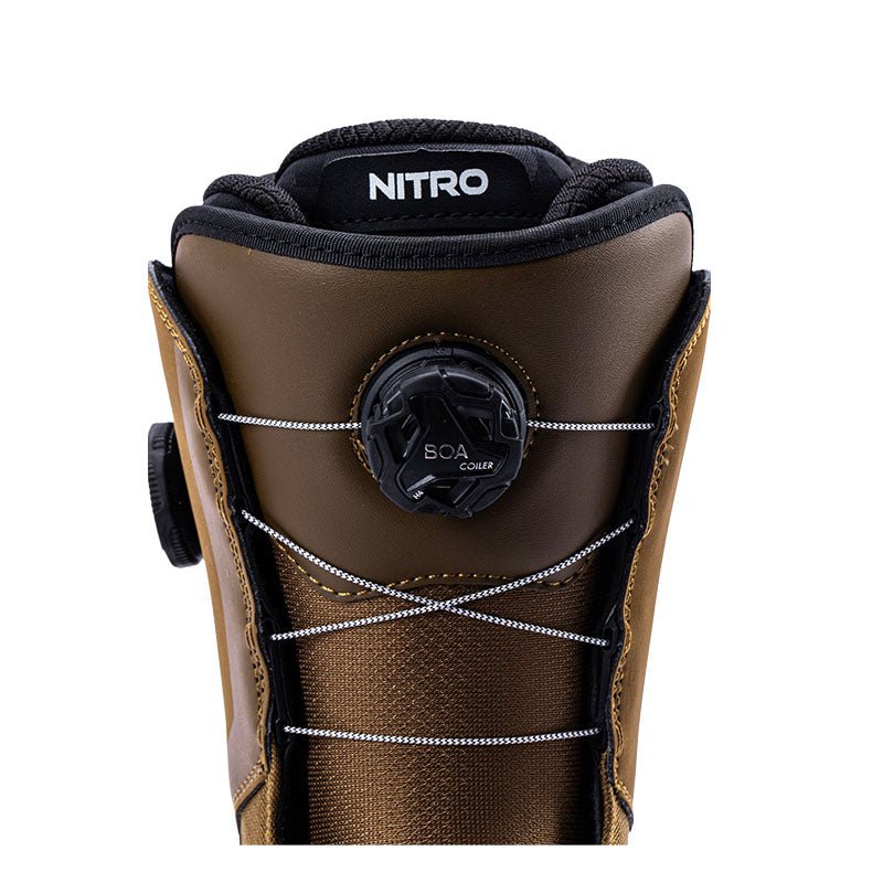 Close-up of a brown and black Nitro snowboard boot featuring a black BOA dial closure system and white laces, set against a solid white background.
