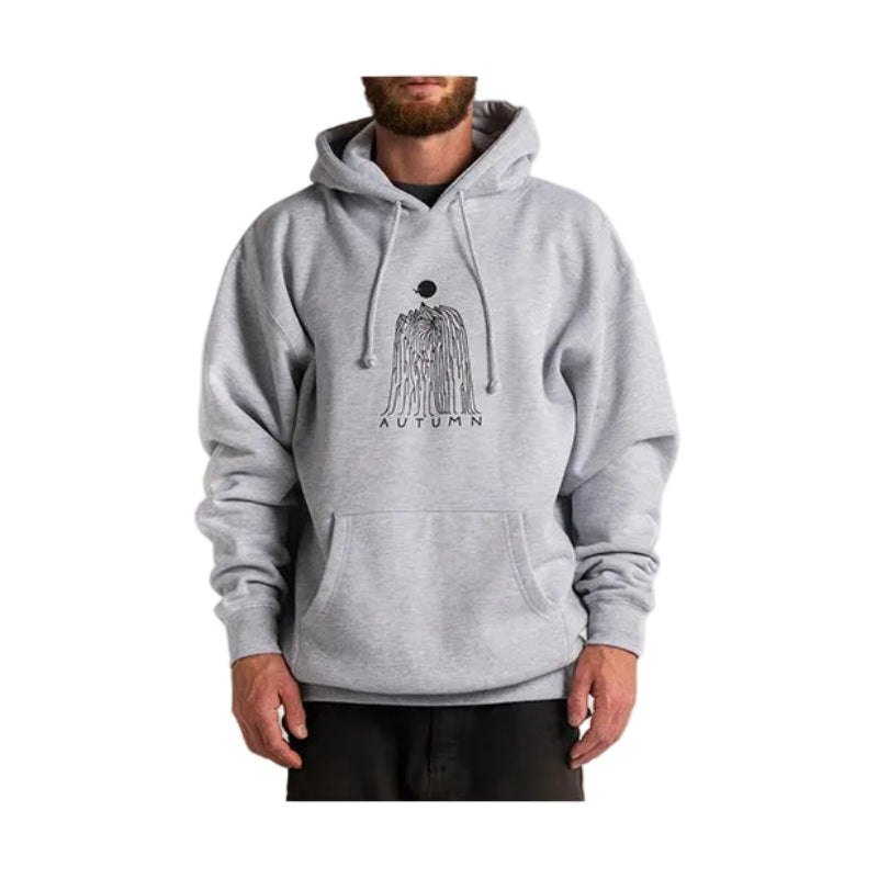 A man wearing a light gray heather pullover hoodie with a black graphic of a skeleton holding a pickaxe and the word 'AUTUMN' printed on the chest, set against a plain light gray background.