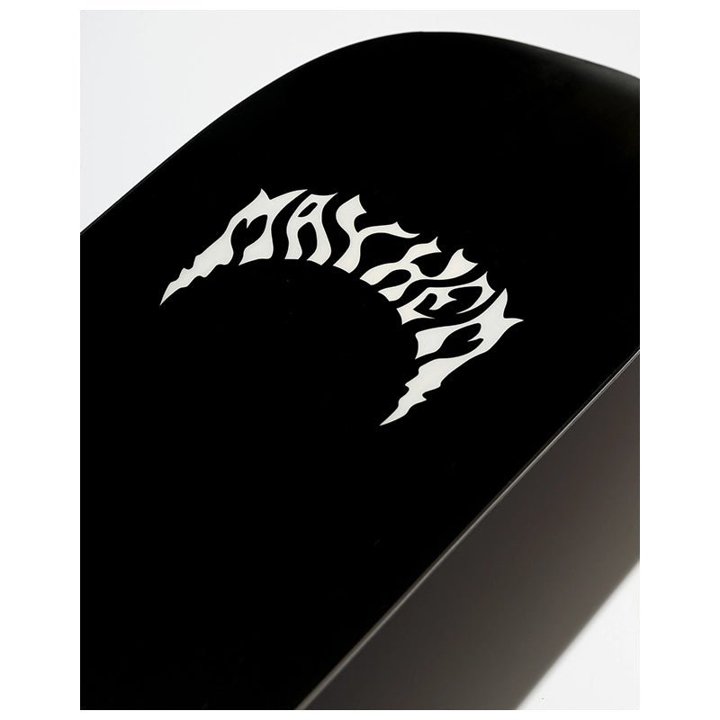 A close-up of a glossy black curved surface featuring a stylized white flame-like graphic, photographed against a light gray background.