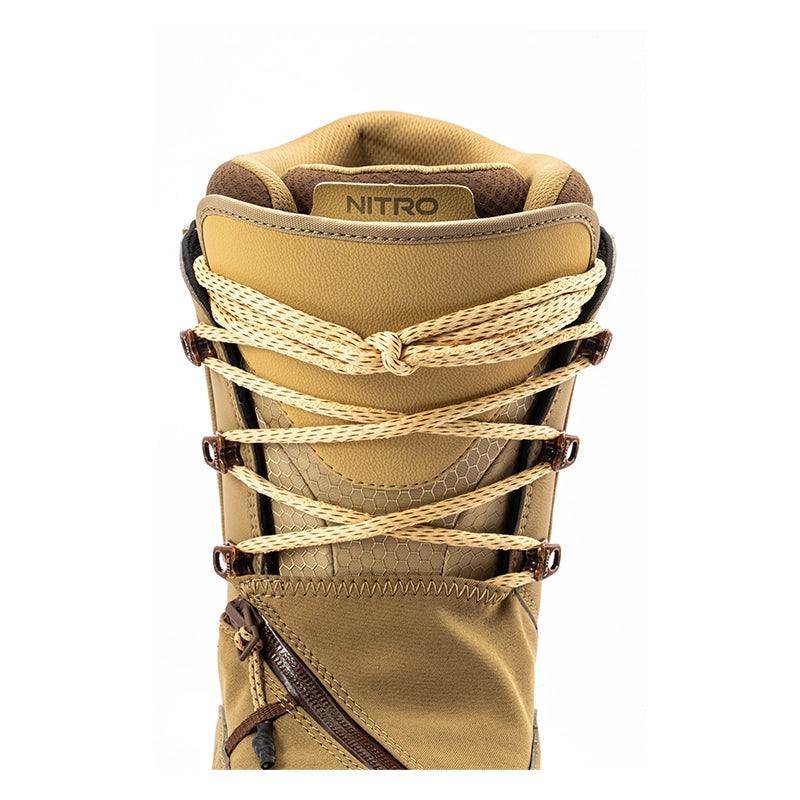 Close-up of a tan and brown boot with thick beige rope laces tied in a knot at the collar, featuring the brand name NITRO on the tongue label.