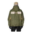 An olive green hooded jacket shown from the back on a mannequin, featuring a beige reflective stripe across the shoulders with a 'G86' logo, black pants, and a beige beanie with a reflective band.