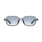 Sunglasses with a clear frame and blue gradient lenses on a light gray background