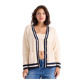 A woman modeling a cream cable-knit cardigan with navy blue trim and wooden buttons, paired with a matching cream crop top and blue jeans, against a solid white background.