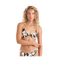A woman modeling a two-piece bikini with a black, white, and beige abstract floral pattern against a light pink studio background.