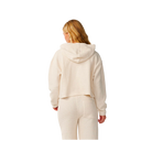 A woman viewed from the back wearing a cream-colored textured cropped hoodie and matching jogger pants against a plain white background.