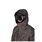 A person wearing a dark gray and black camouflage hooded ski jacket with black ski goggles, shown against a plain white background.