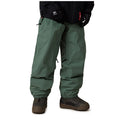 A person wearing dark green snow pants with elastic cuffs, paired with brown snowboard boots and a black jacket, shown from the waist down on a white background.