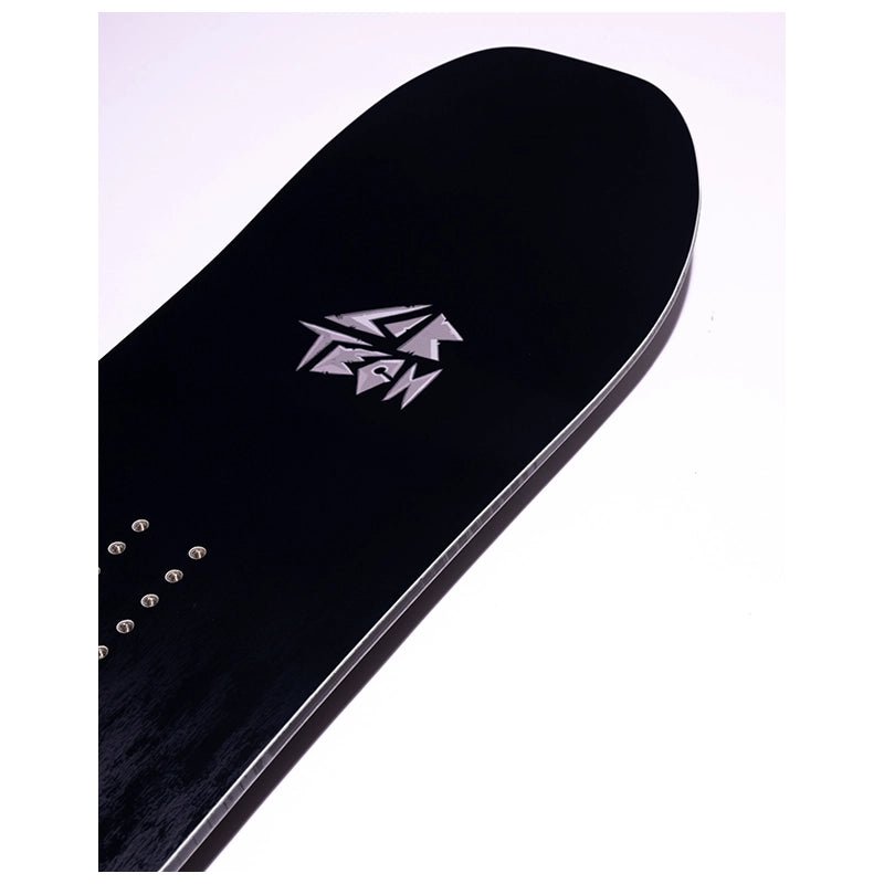 Close-up of a black snowboard deck with a silver geometric logo and binding hardware, photographed on a plain light background.