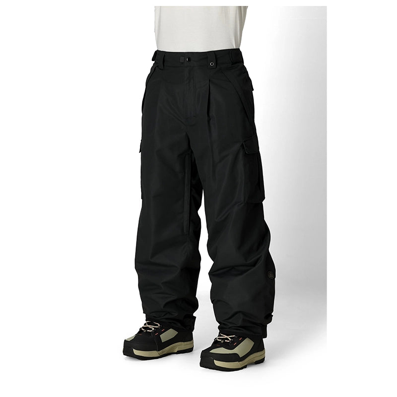 Black cargo snow pants shown on a model from the waist down, paired with black and olive platform snowboard boots against a white studio background.