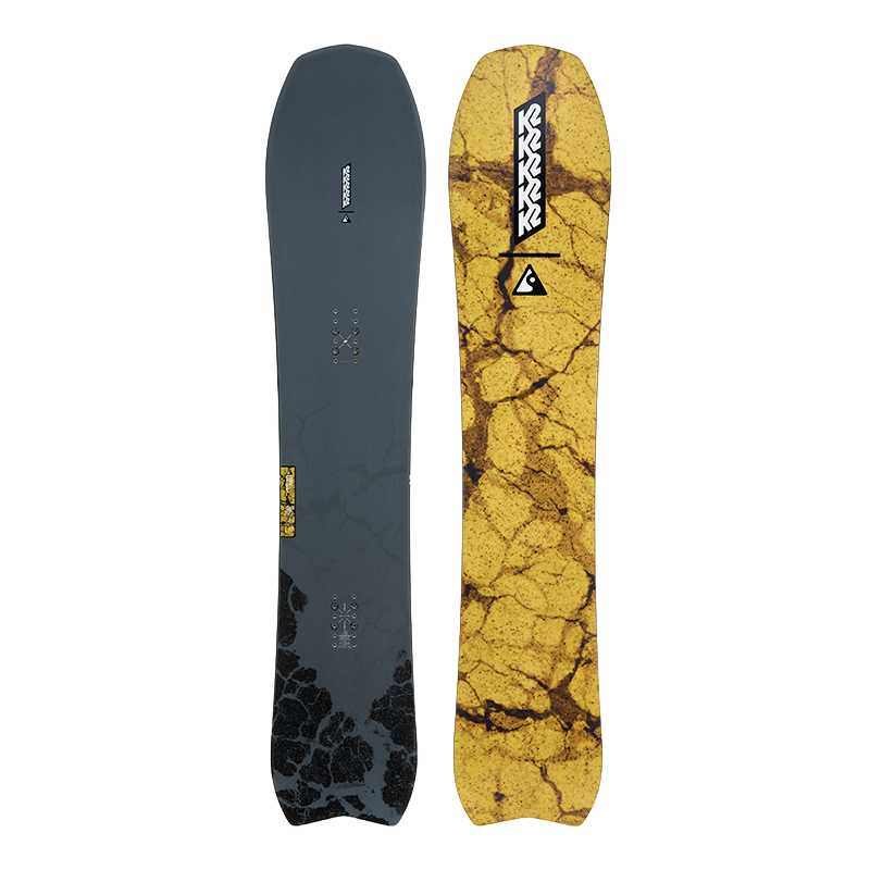 Two views of a Rossignol snowboard side-by-side: one showing the dark slate gray base with black graphic patterns and the other showing the vibrant yellow and brown cracked-glass style top graphic.