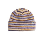 A knit beanie hat with horizontal stripes in purple, mustard yellow, and cream, featuring a small white embroidered logo patch on the folded cuff.