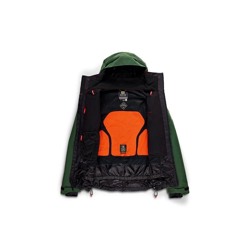 A hooded technical jacket shown open against a white background, featuring dark green sleeves and hood, a black interior lining, and a prominent bright orange padded back panel.