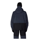 A person shown from the back wearing a dark hooded jacket with a dark ribbed upper section and black lower section, paired with dark pants and a black beanie, on a plain white background.