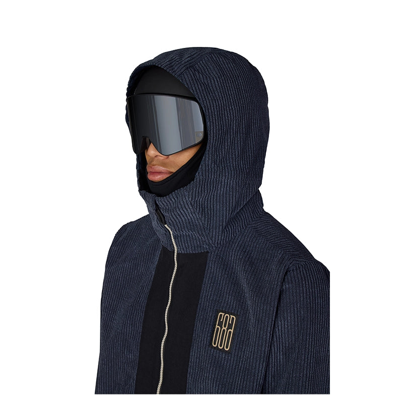 A person wearing a dark navy ribbed hooded jacket with a black face mask and dark ski goggles, shown against a plain white background.
