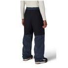 A person shown from the back wearing wide-leg pants with a solid black upper section and dark blue ribbed lower legs, paired with a cream long-sleeve top and black sneakers.