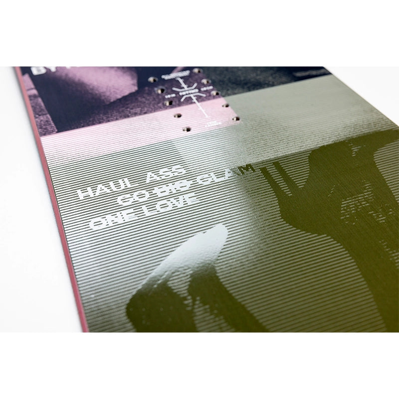 A close-up of a printed music cover or booklet page with the text 'HAUL ASS CO-DOG-CLAM ONE LOVE' over a striped gray-green background and a dark silhouette, photographed on a white surface.