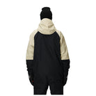 A person shown from the back wearing a color-blocked hooded jacket with a black body and sleeves, and a light beige upper back and hood, along with a black beanie against a plain white background.