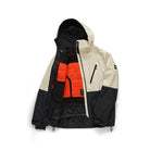 A hooded color-blocked ski jacket shown open against a white background. The jacket features a cream upper section, black lower sections and hood, and a bright orange quilted chest panel.