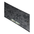 A long, thin rectangular product shown at an angle on a plain white background. The surface is dark charcoal gray with a mottled, textured pattern and a small multicolor label or patch near one end.