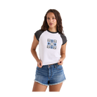 A woman modeling a white raglan t-shirt with dark gray sleeves and collar, featuring a blue graphic print on the chest, paired with denim shorts against a plain white background.