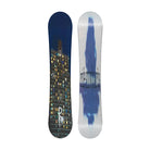 A snowboard shown from both sides against a light gray background. The left side features a dark navy blue night-sky and cityscape graphic with illuminated building windows, while the right side has a white base with a blue abstract splash and stylized black text.