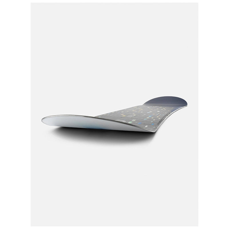 A snowboard with a dark gray and silver patterned base, shown from a low angle against a light gray background.