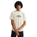 Person wearing a white t-shirt with a logo, standing against a neutral background