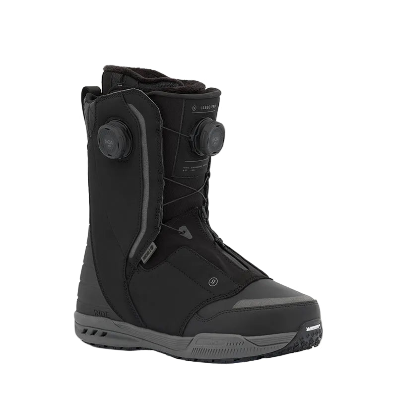 A black Ride snowboard boot with a dial closure system, shown from a three-quarters angle against a light gray background.