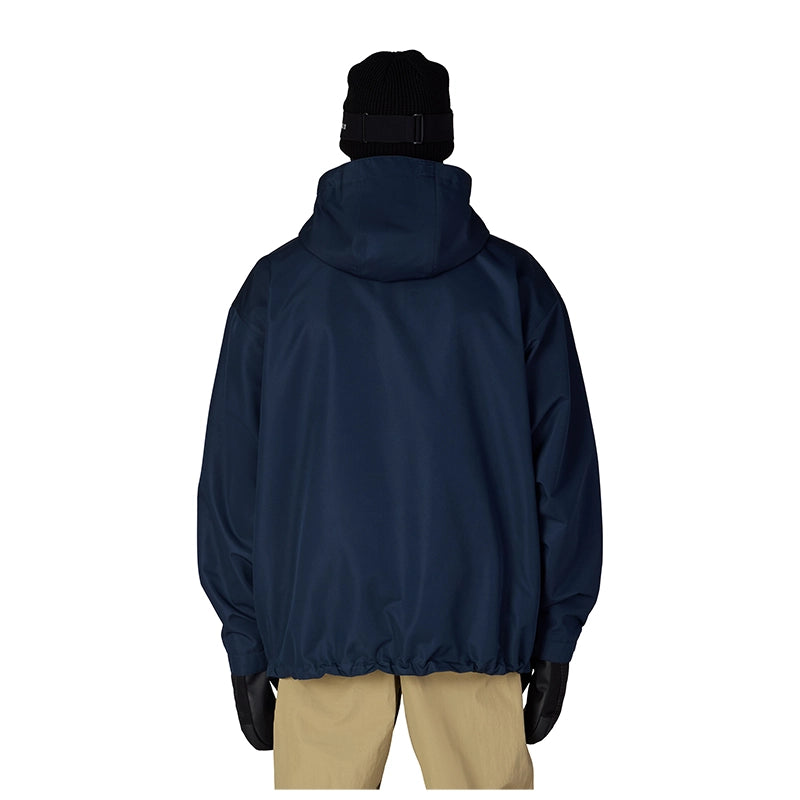 A person shown from the back wearing a dark navy hooded jacket, a black beanie, black gloves, and tan pants against a plain white background.