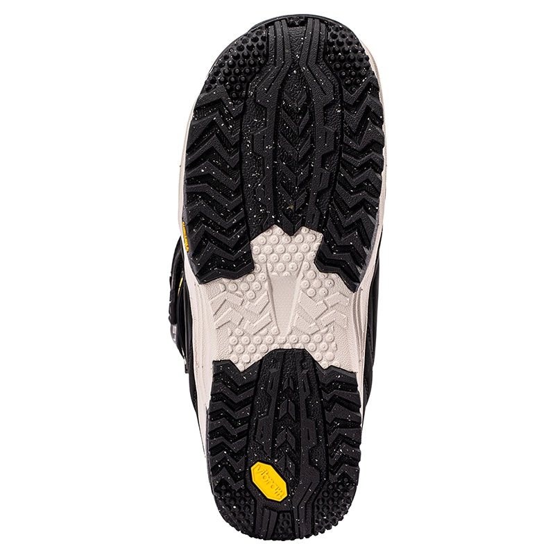 Top-down view of a shoe sole showing a black treaded outsole with a white textured center section and a small yellow Vibram logo near the heel, on a white background.