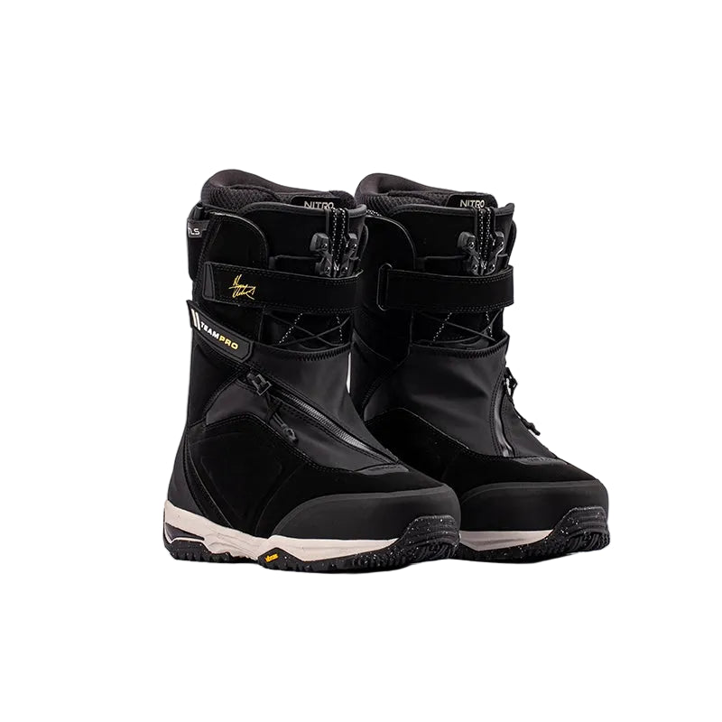 A pair of black snowboard boots with white and gold accents, displayed against a clean white background.