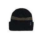 A black ribbed knit beanie hat with three horizontal gold dotted stripes across the upper portion and a small black brand tag on the folded cuff, shown against a plain white background.