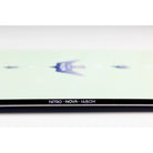 Close-up of the bottom edge of a light green flat product with a black strip along the bottom edge, featuring white text that reads 'NITRO - NOVA - 148CM'.