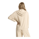 A woman shown from the back wearing a light cream-colored hooded sweatshirt and matching sweatpants against a plain white background.