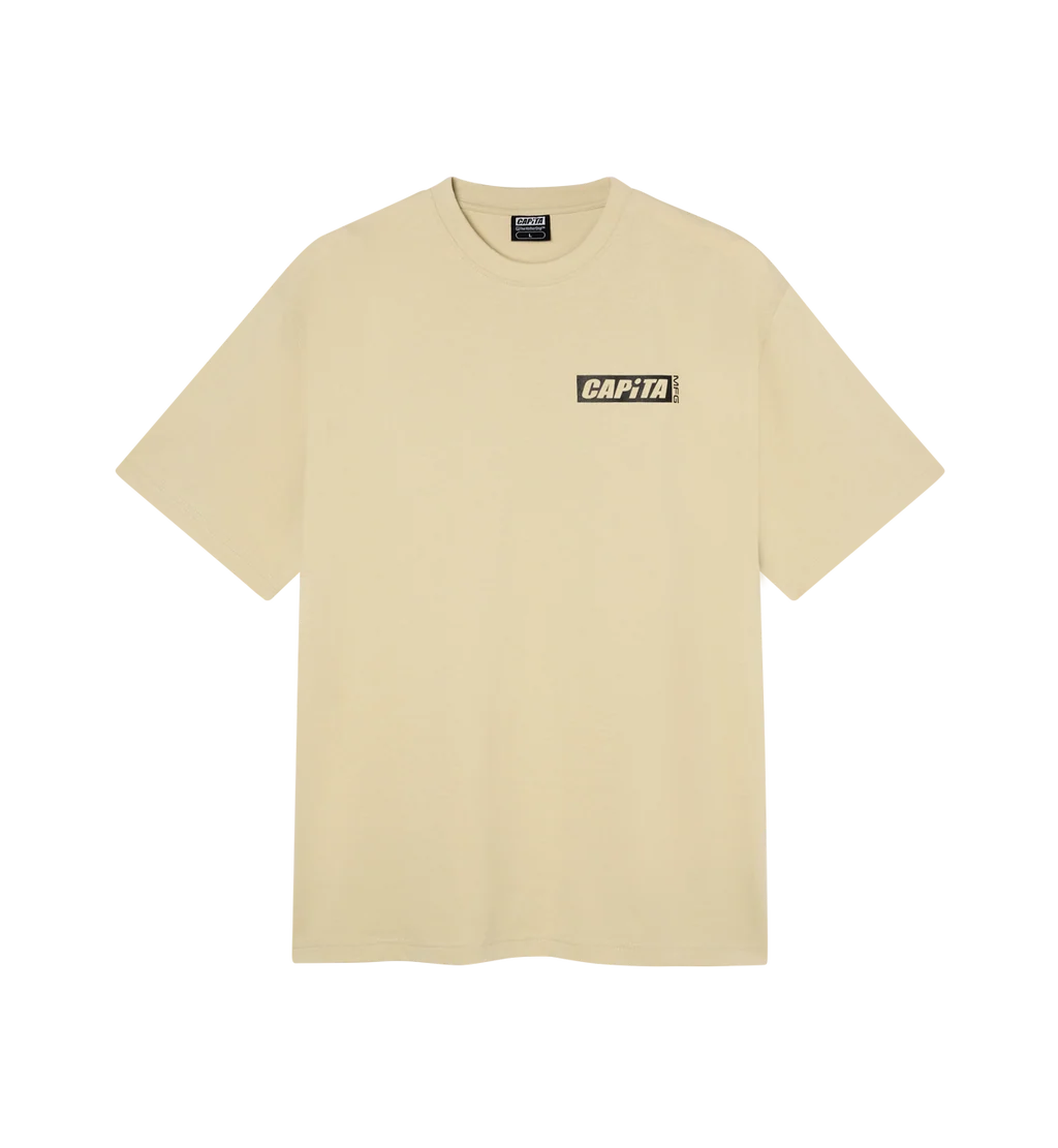 A light beige short-sleeve t-shirt with a small black and white 'CAPiTA' box logo printed on the left chest, displayed on a clean white background.