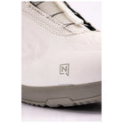 Close-up of a white snowboard boot showing the side profile, textured white upper, white laces, a gray sole, and a gray stylized 'N' logo on the side.